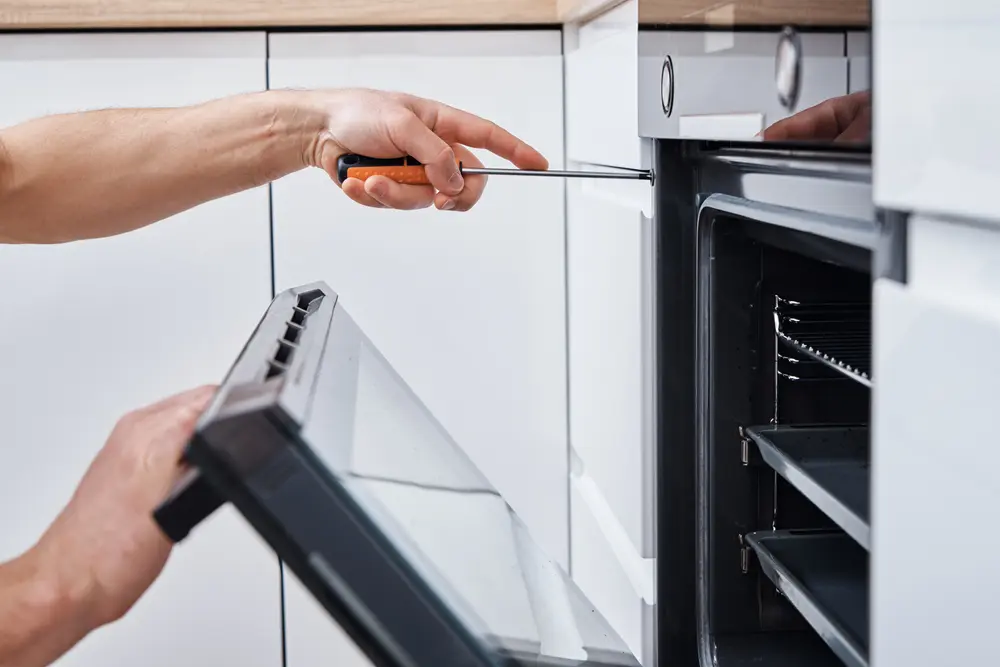 Technician troubleshooting oven temperature issues for reliable oven repair